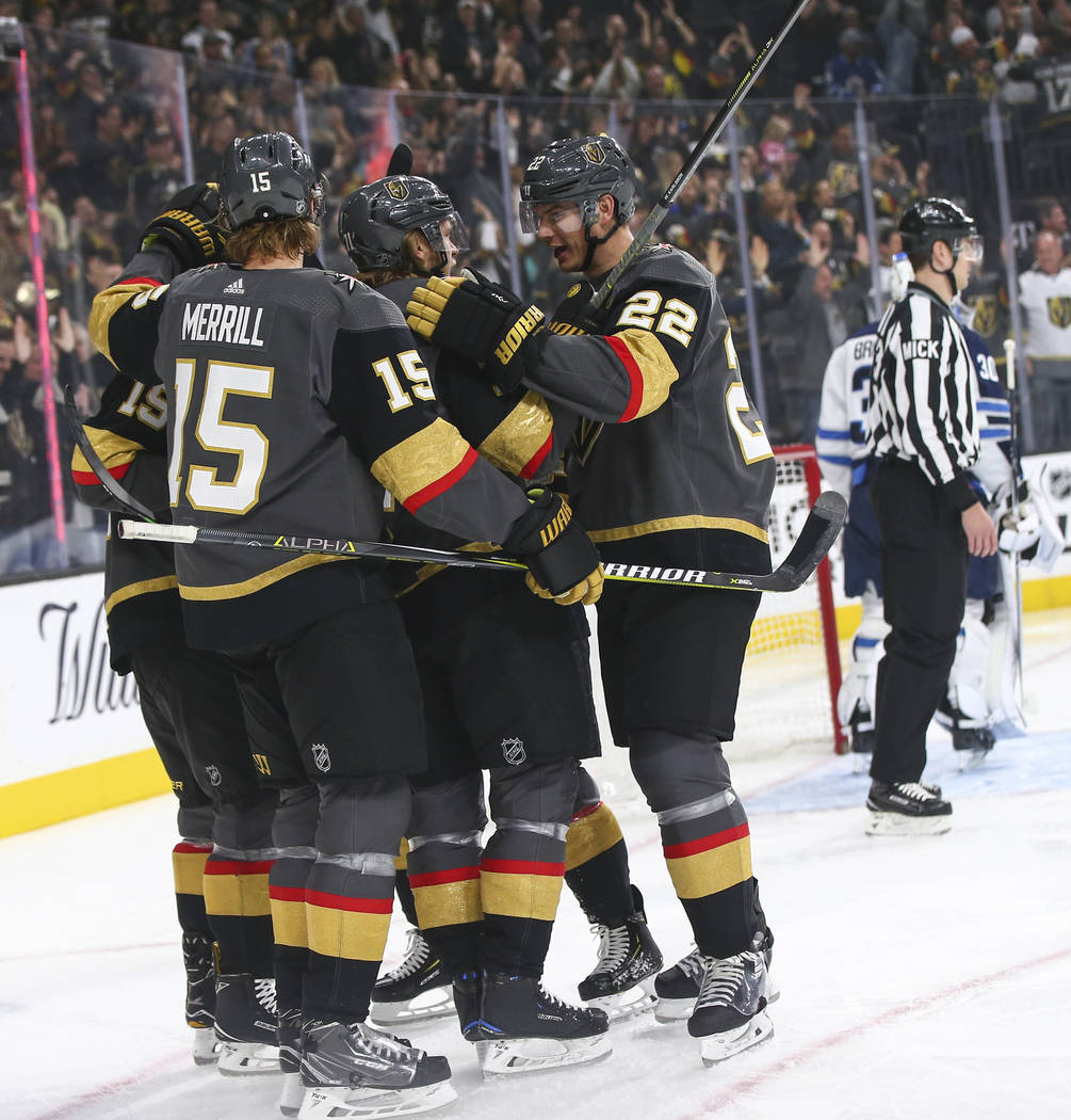 Golden Knights players celebrate their first goal against the Winnipeg Jets during the first period of an NHL hockey game at T-Mobile Arena in Las Vegas on Thursday, March 21, 2019. (Chase Stevens ...