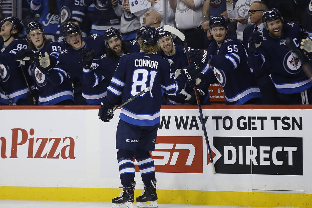 Winnipeg Jets celebrate from the bench as Kyle Connor (81) skates by during the second period of an NHL hockey game against the Nashville Predators, Saturday, March 23, 2019 in Winnipeg, Manitoba. ...