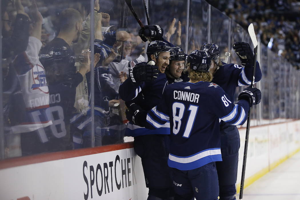 Winnipeg Jets' Kevin Hayes (12) celebrates his goal with Jacob Trouba (8), Kyle Connor (81) and Patrik Laine (29) during the second period of an NHL hockey game, Saturday, March 23, 2019 in Winnip ...