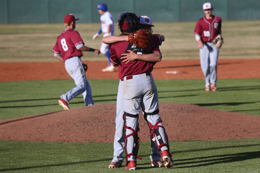 Desert Oasis pitcher Josh Sharman (11) hugs teammate Parker Schmidt (4) after getting the last out of the game to win 4-0 against Bishop Gorman in the baseball game at Bishop Gorman High School in ...