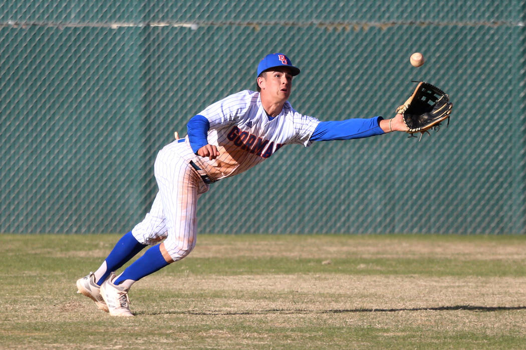 Bishop Gorman's Carson Wells (9) dives for a catch in the outfield against Desert Oasis in the baseball game at Bishop Gorman High School in Las Vegas, Thursday, March 21, 2019. Desert Oasis won 4 ...