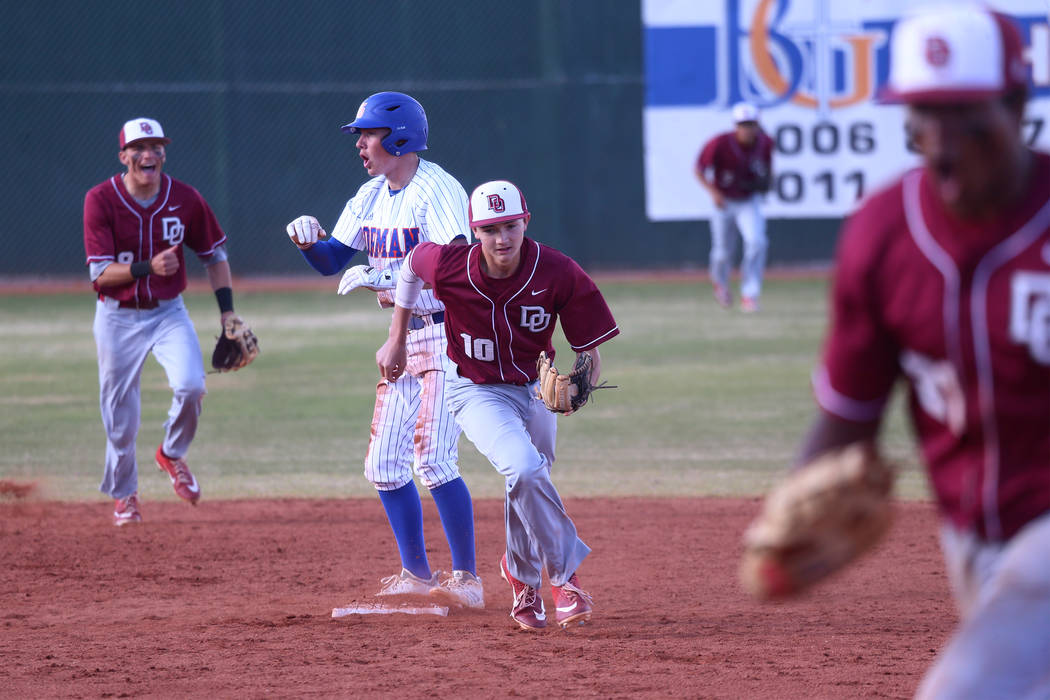 Bishop Gorman's Cameron Hougham (1) reacts after getting picked off at second base with a tag from Desert Oasis' Colby Smith (10) in the baseball game at Bishop Gorman High School in Las Vegas, Th ...