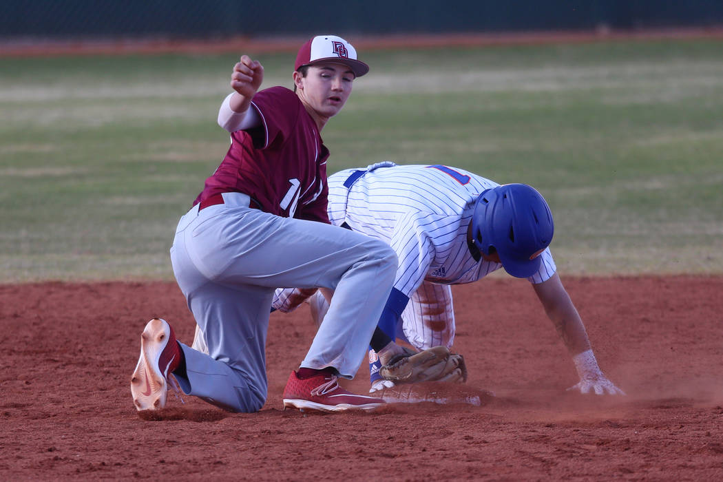 Bishop Gorman's Cameron Hougham (1) is picked off at second base by Desert Oasis' Colby Smith (10) in the baseball game at Bishop Gorman High School in Las Vegas, Thursday, March 21, 2019. Desert ...