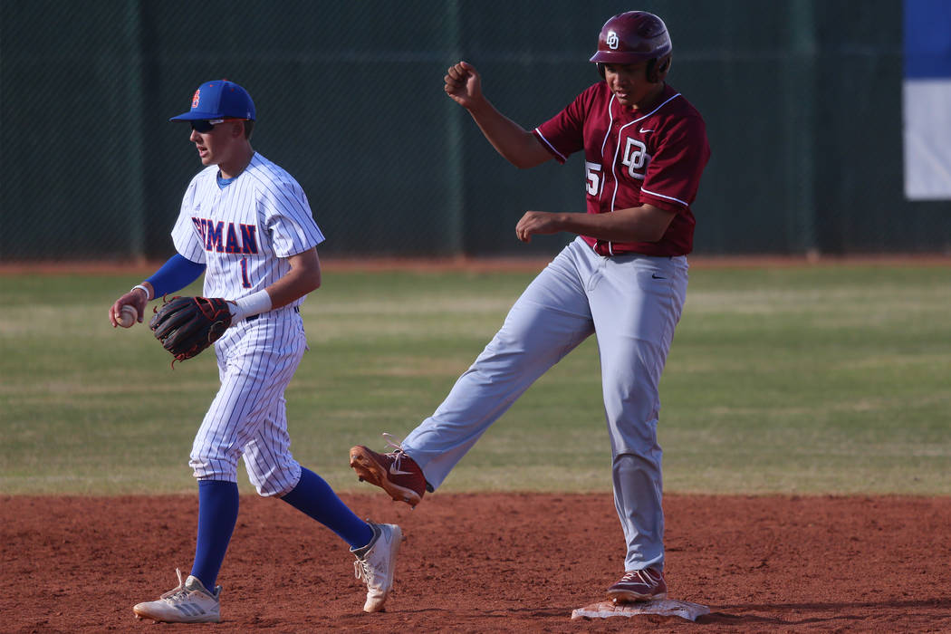 Desert Oasis' Aaron Roberts (25) reacts after a two run hit, with Bishop Gorman's Cameron Hougham (1) returning the ball to the pitcher, in the baseball game at Bishop Gorman High School in Las Ve ...