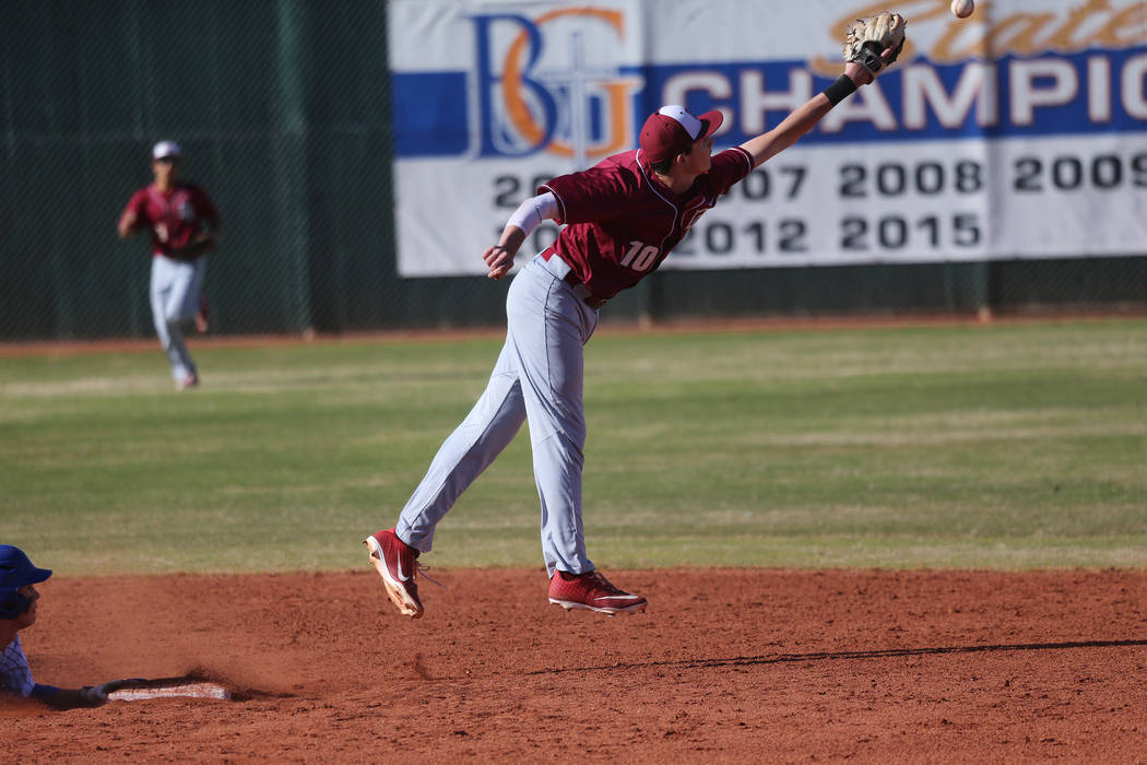 Desert Oasis' Colby Smith (10) misses an over thrown ball to second base at second base against Bishop Gorman in the baseball game at Bishop Gorman High School in Las Vegas, Thursday, March 21, 20 ...