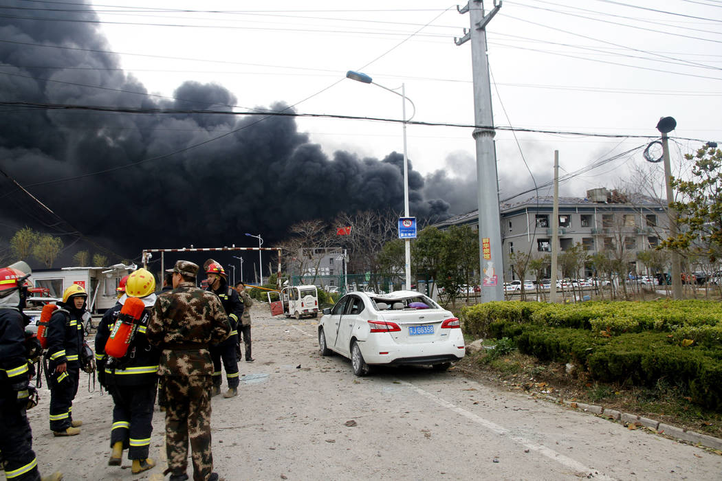 In this Thursday, March 21, 2019, photo, rescuers walk near the site of a factory explosion in a chemical industrial park in Xiangshui County of Yancheng in eastern China's Jiangsu province. The l ...