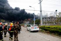 In this Thursday, March 21, 2019, photo, rescuers walk near the site of a factory explosion in a chemical industrial park in Xiangshui County of Yancheng in eastern China's Jiangsu province. The l ...