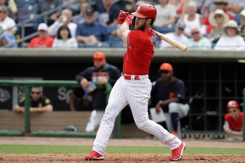 Philadelphia Phillies' Bryce Harper follows through on his single off Detroit Tigers starting pitcher Spencer Turnbull during the fourth inning of a spring training baseball game Wednesday, March ...