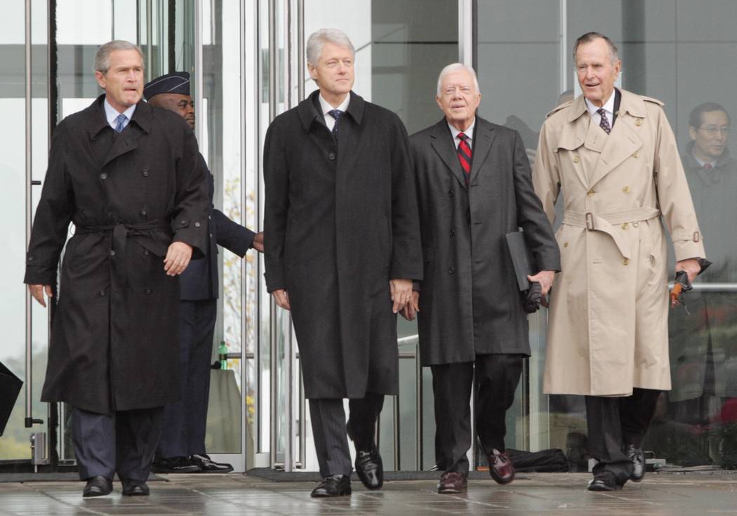 President George W. Bush, left to right, former President Bill Clinton, former President Jimmy Carter and former President George H.W. Bush, walk from the William J. Clinton Presidential Center to ...