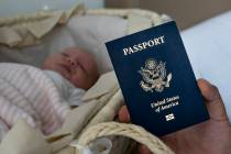 In this photo taken on Jan. 24, 2019, Denis Wolok, the father of 1-month-old Eva's father, shows the child's U.S. passport during an interview with The Associated Press in Hollywood, Fla. Every ye ...