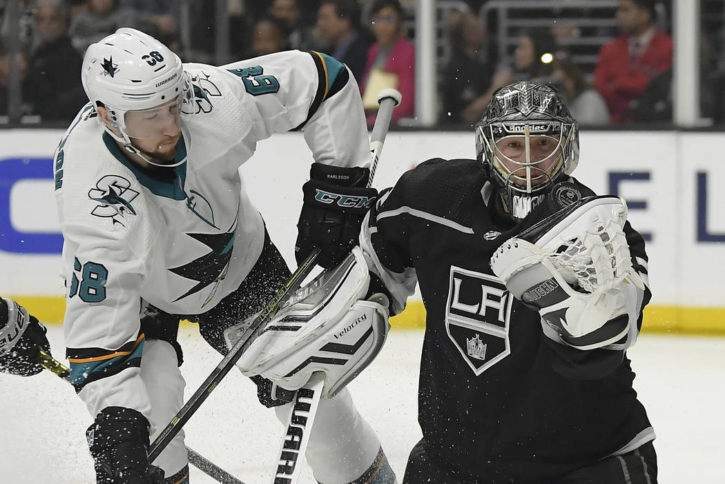 Los Angeles Kings goaltender Jonathan Quick, right, makes a glove save on a shot by San Jose Sharks center Melker Karlsson during the third period of an NHL hockey game Thursday, March 21, 2019, i ...