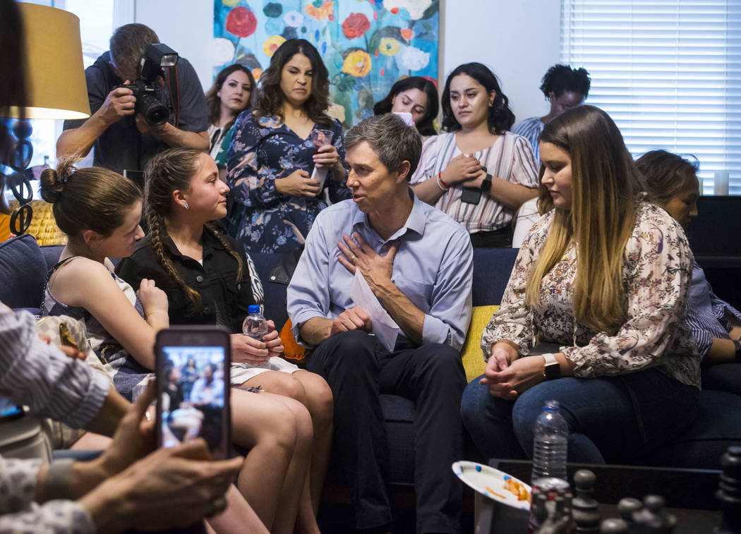 Eleven-year-old Karola Garcia, second from left, is comforted by Katie Rosenblum, left, as Garcia, along with sister Karla Garcia, right, talk with Democratic presidential candidate and former Tex ...