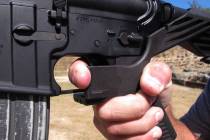 Shooting instructor Frankie McRae illustrates the grip on an AR-15 rifle fitted with a "bump stock" at his 37 PSR Gun Club in Bunnlevel, N.C., on Wednesday, Oct. 4, 2017. The stock uses the recoil ...