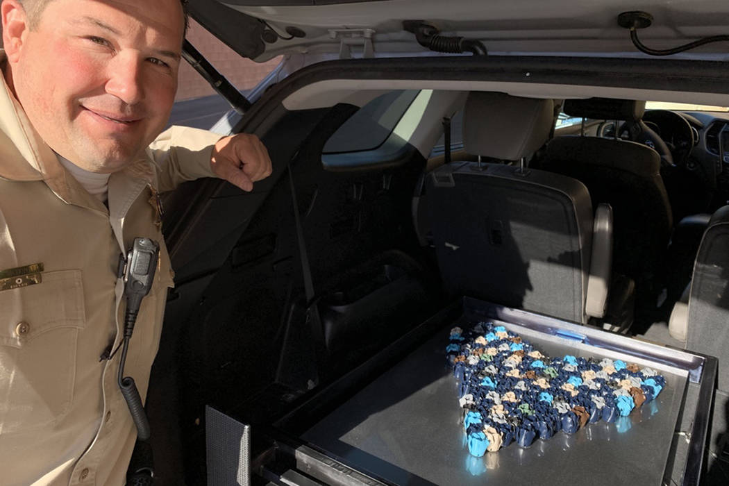 Metropolitan Police Department detective Darryl McDonald prepares to unload his artwork at the Las Vegas Review-Journal photo studio Monday, March 25, 2019. McDonald created the piece for the &#xd ...