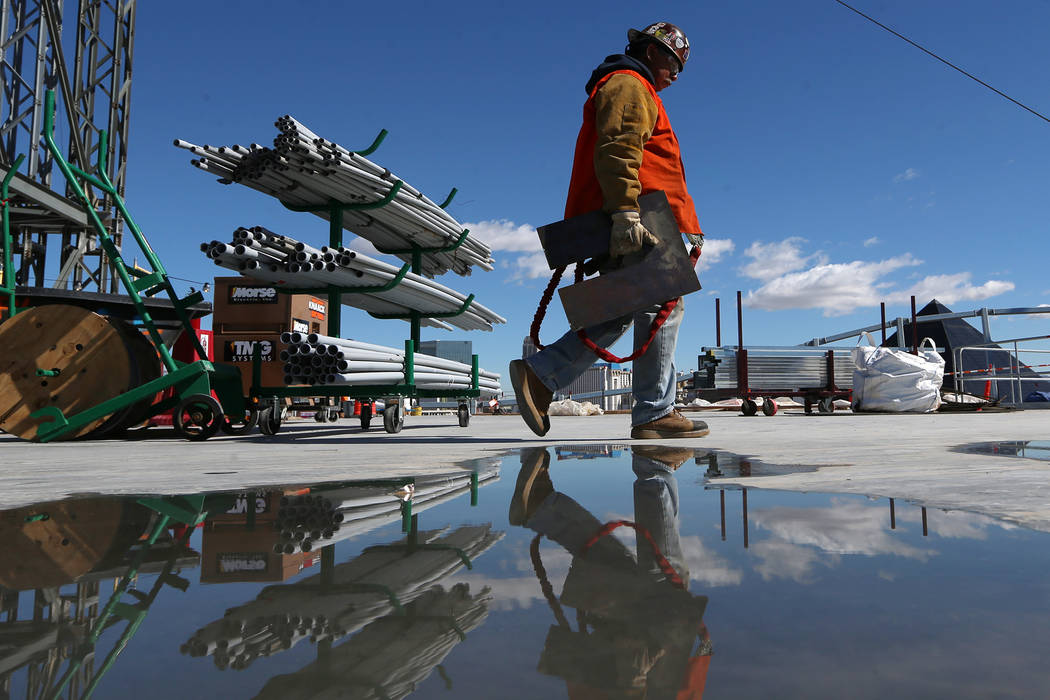 A worker carries equipment at the Raiders stadium construction site in Las Vegas, Friday, March 22, 2019. Erik Verduzco Las Vegas Review-Journal @Erik_Verduzco