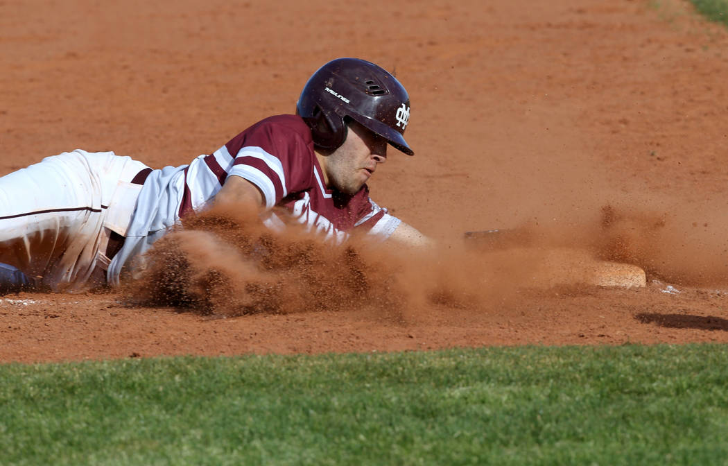 Cimarron-Memorial baserunner Lawrence Campa (15) slides safely into third base in the third inning of their baseball game at Cimarron-Memorial High School in Las Vegas Friday, March 22, 2019. (K.M ...