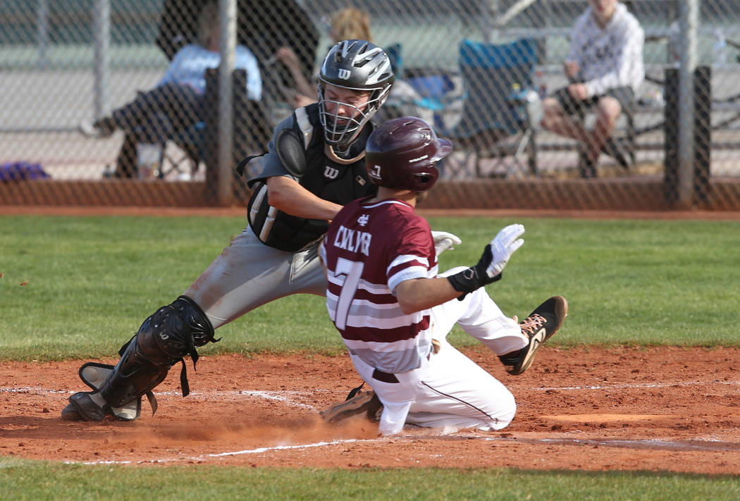 Silverado catcher Brant Hunt (18) tags out Cimarron-Memorial Zach Culver (7) at home in the third inning of their baseball game at Cimarron-Memorial High School in Las Vegas Friday, March 22, 2019 ...