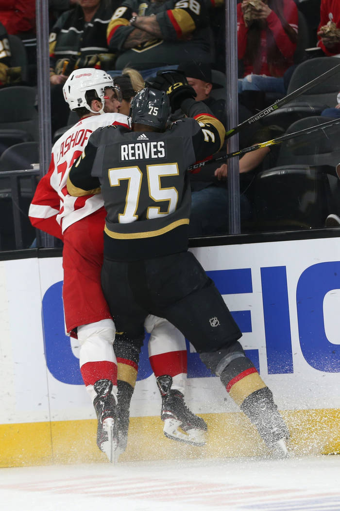 Vegas Golden Knights right wing Ryan Reaves (75) slams Detroit Red Wings defenseman Brian Lashoff (32) against the glass during the second period of an NHL hockey game at T-Mobile Arena in Las Veg ...