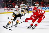 Detroit Red Wings defenseman Danny DeKeyser (65) knocks the puck away from Vegas Golden Knights right wing Reilly Smith (19) in the third period of an NHL hockey game Thursday, Feb. 7, 2019, in De ...