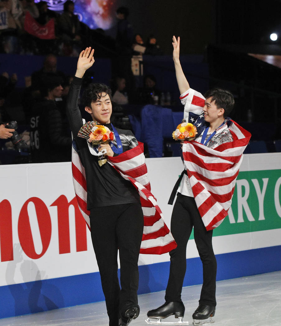 Nathan Chen from the U.S., left, and compatriot Vincent Zhou acknowledge the crowd after winning the gold and bronze medals respectively for the men's free skating routine during the ISU World Fig ...