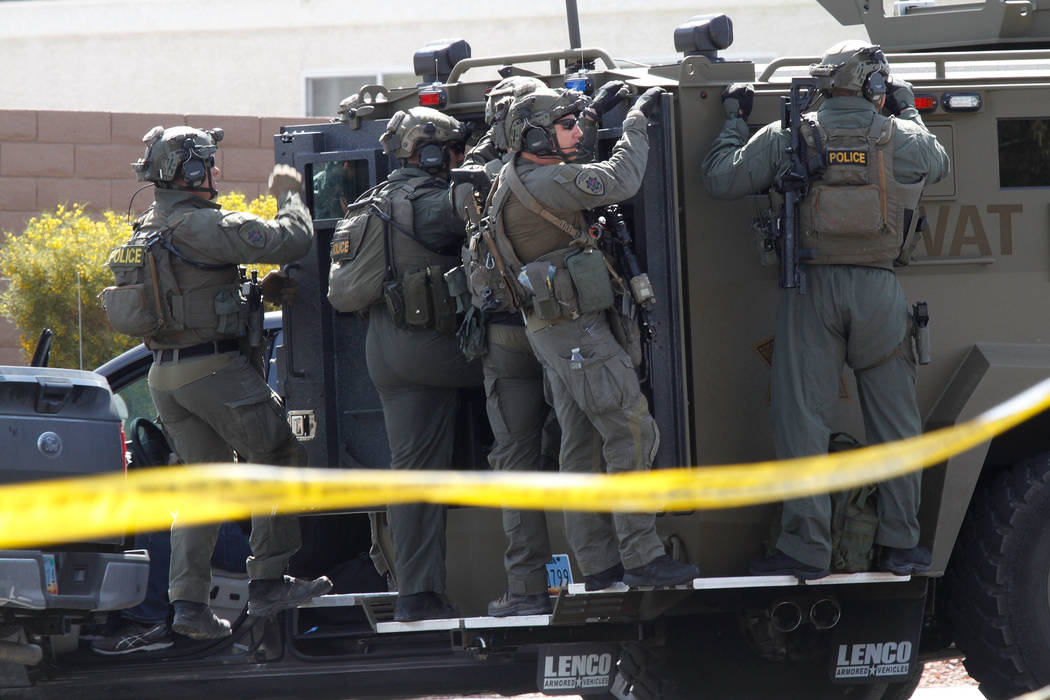 A SWAT vehicle carries a Metropolitan Police Department SWAT team during a barricade situation near Grand Teton and Durango in the northwest area of the Las Vegas valley, Saturday, March 23, 2019 ...