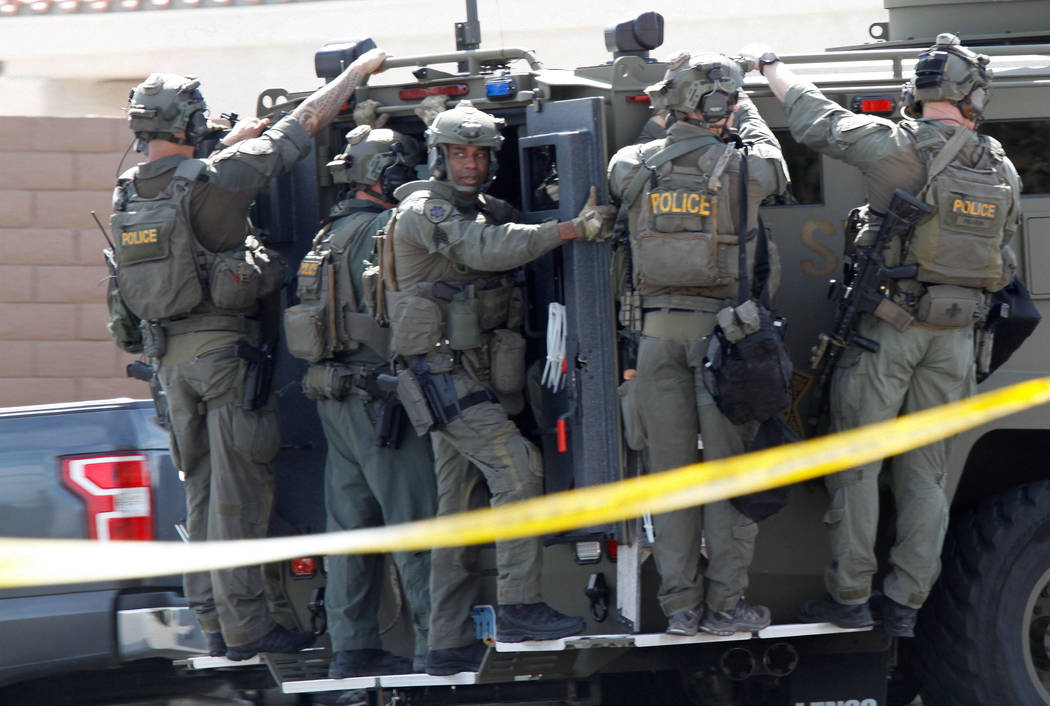 A SWAT vehicle carries a Metropolitan Police Department SWAT team during a barricade situation near Grand Teton and Durango in the northwest area of the Las Vegas valley, Saturday, March 23, 2019 ...