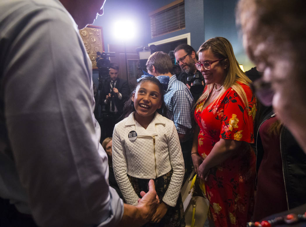 Nine-year-old Mia Mendez talks with Democratic presidential candidate and former Texas congressman Beto O'Rourke during a campaign stop at a home in the Summerlin area of Las Vegas on Saturday, Ma ...