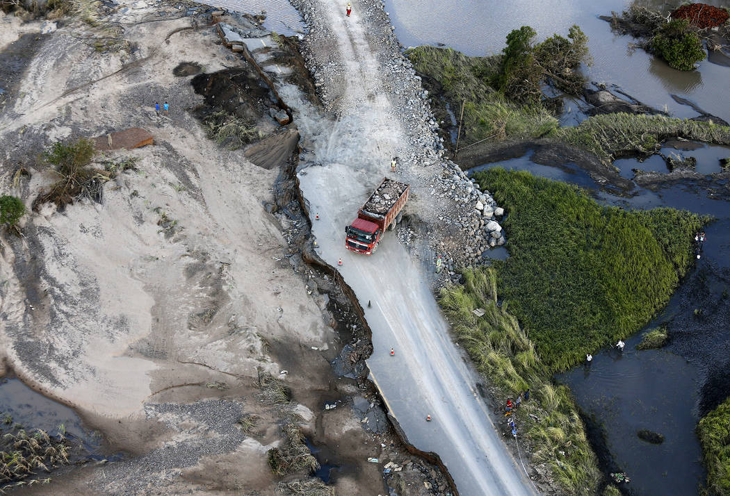 An aerial photo shows a truck as it manoeuvres on a damaged road following the devastating Tropical Cyclone Idai in Beira, Mozambique, Saturday, March 23, 2019. A second week has begun with effort ...