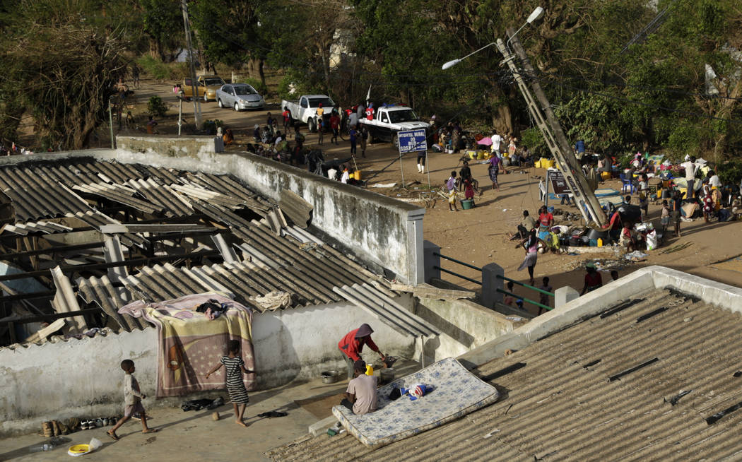 Displaced families set up their bedding on top of the roof in Buzi district, 200 kilometers (120 miles) outside Beira, Mozambique, on Saturday, March 23, 2019. A second week has begun with efforts ...