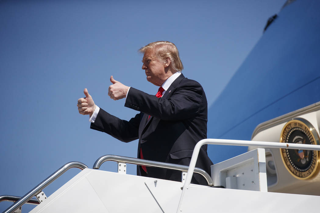 President Donald Trump gives the thumbs-up as he arrives on Air Force One, Friday, March 22, 2019, at Palm Beach International Airport, in West Palm Beach, Fla., en route to Mar-a-Lago in Palm Bea ...