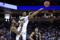 Duke forward RJ Barrett (5) passes to a teammate, away from Central Florida forward Chad Brown, left, during the first half of a second-round game in the NCAA men's college basketball tournament S ...