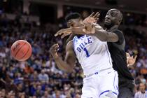 Central Florida center Tacko Fall (24) defends against Duke forward Zion Williamson (1) during the first half of a second-round game in the NCAA men's college basketball tournament Sunday, March 2 ...