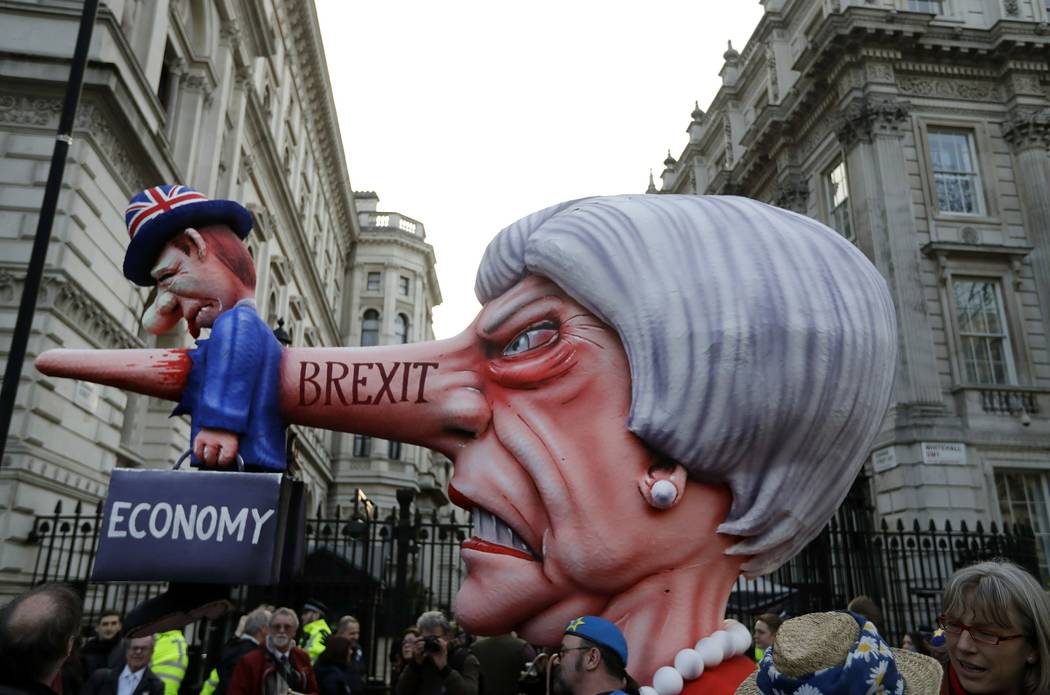 An effigy of British Prime Minister Theresa May passes by Downing Street during a Peoples Vote anti-Brexit march in London, Saturday, March 23, 2019. Anti-Brexit protesters swarmed the streets of ...