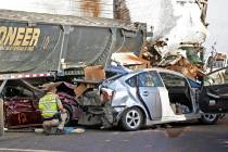 In this Oct. 29, 2013, file photo, Arizona Department of Public Safety officers investigate a multiple fatality accident involving six semi tractor-trailers and 19 other vehicles after a dust stor ...