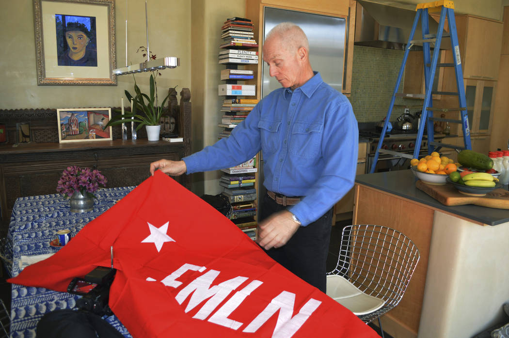 In this Jan. 17, 2019 photo, Todd Greentree, a former U.S. Embassy political officer in El Salvador during its civil war, shows a rebel Farabundo Marti National Liberation Front flag in his Santa ...