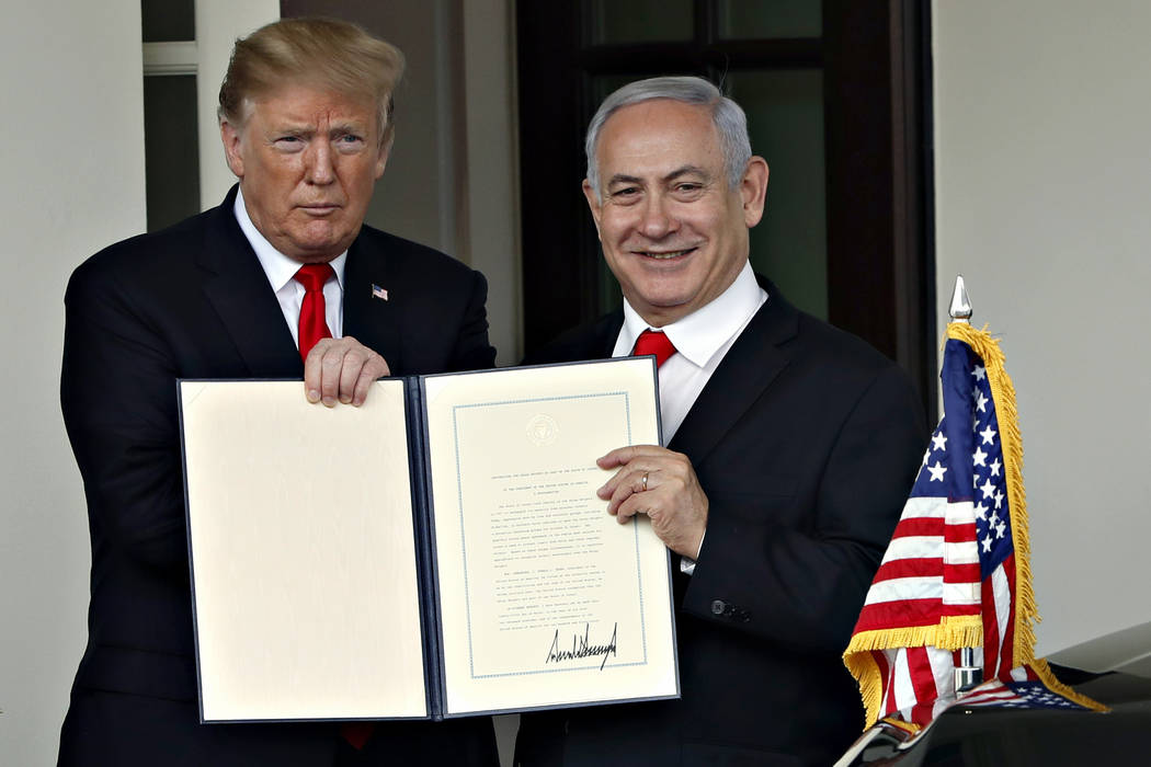 President Donald Trump and Israeli Prime Minister Benjamin Netanyahu hold up a signed proclamation, after their meeting as the Prime Minister leaves the White House, Monday March, 25, 2019, in Was ...