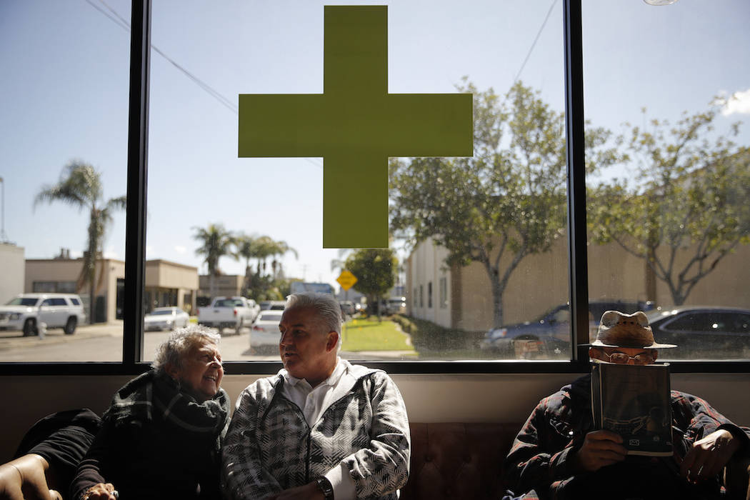 In this Feb. 19, 2019 photo, Kay Nelson, left, and Bryan Grode, retried seniors from Laguna Woods Village, chat in the lobby of Bud and Bloom cannabis dispensary while waiting for a free shuttle t ...