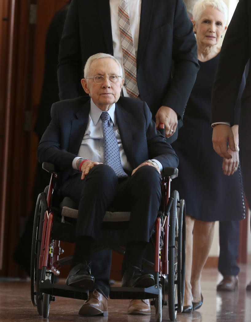 Former U.S. Sen. Harry Reid, who sued the makers of an exercise band after injuring his eye, leaves the courtroom with his wife, Landra Gould, after attending the first day of jury selection in Re ...