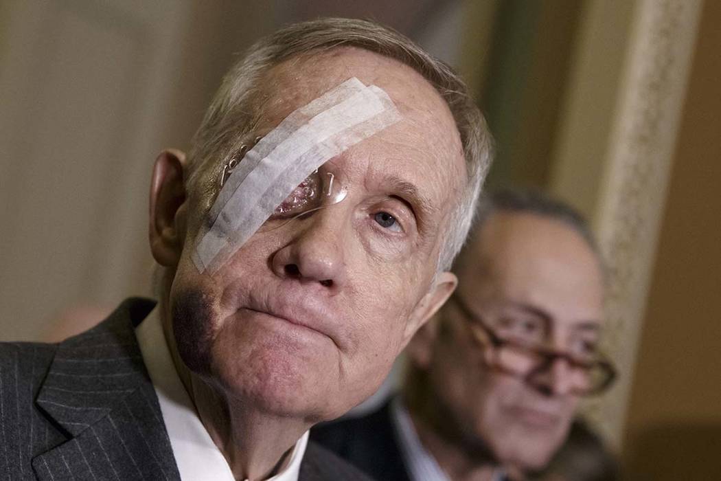 Then-Senate Minority Leader Harry Reid of Nevada, joined by Sen. Charles Schumer, D-N.Y., takes questions from reporters during a news conference on Capitol Hill in Washington on Feb. 10, 2015, fo ...