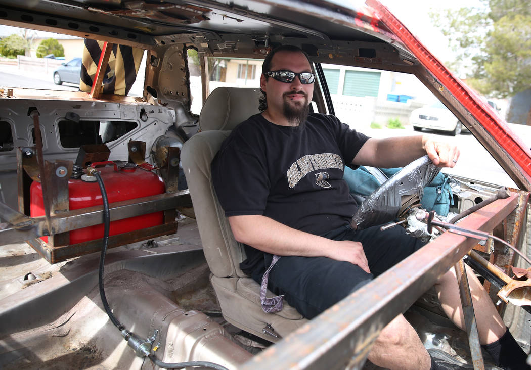 Andrew Carmean, a demolition driver, poses for a photo inside his 1988 Lincoln Town Car on Tues ...