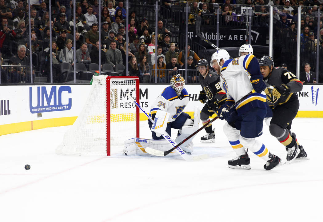 Vegas Golden Knights right wing Ryan Reaves (75) skates toward St. Louis Blues center Tyler Bozak (21) as he goes after the puck during the first period of their NHL game in Las Vegas, Friday, Nov ...