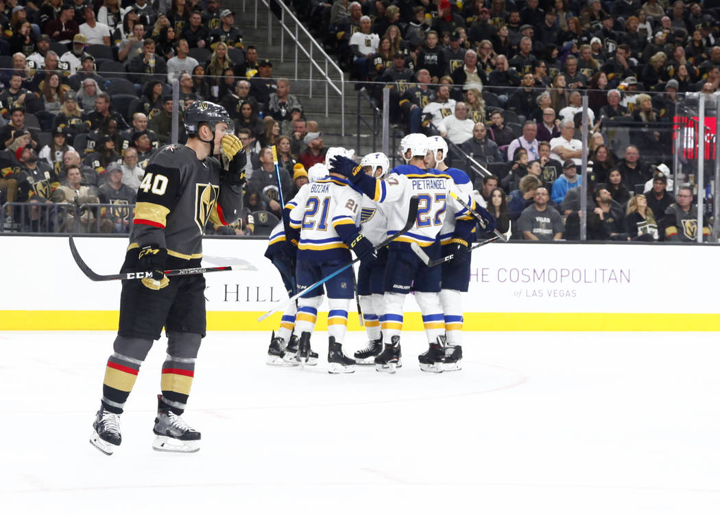 Vegas Golden Knights center Ryan Carpenter (40) skates past the St. Louis Blues players as they celebrate a goal by St. Louis Blues center Brayden Schenn (10), not pictured, during the second peri ...