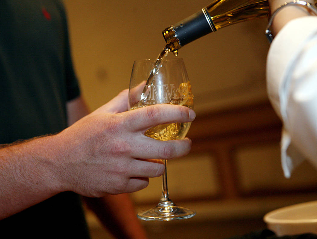 Sean Connolly receives a pour of wine at the Paris Hotel and Casino, 3655 Las Vegas Blvd., during UNLVino Saturday, April 5, 2008. UNLVino is the longest running wine tasting event in Las Vegas. V ...