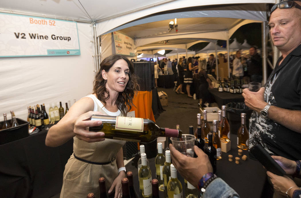 Guest sample wines at the V2 Wine Group booth during the 44th Annual UNLVino fundraiser at the Keep Memory Alive Event Center at Cleveland Clinic Lou Ruvo Center for Brain Health in Las Vegas on S ...