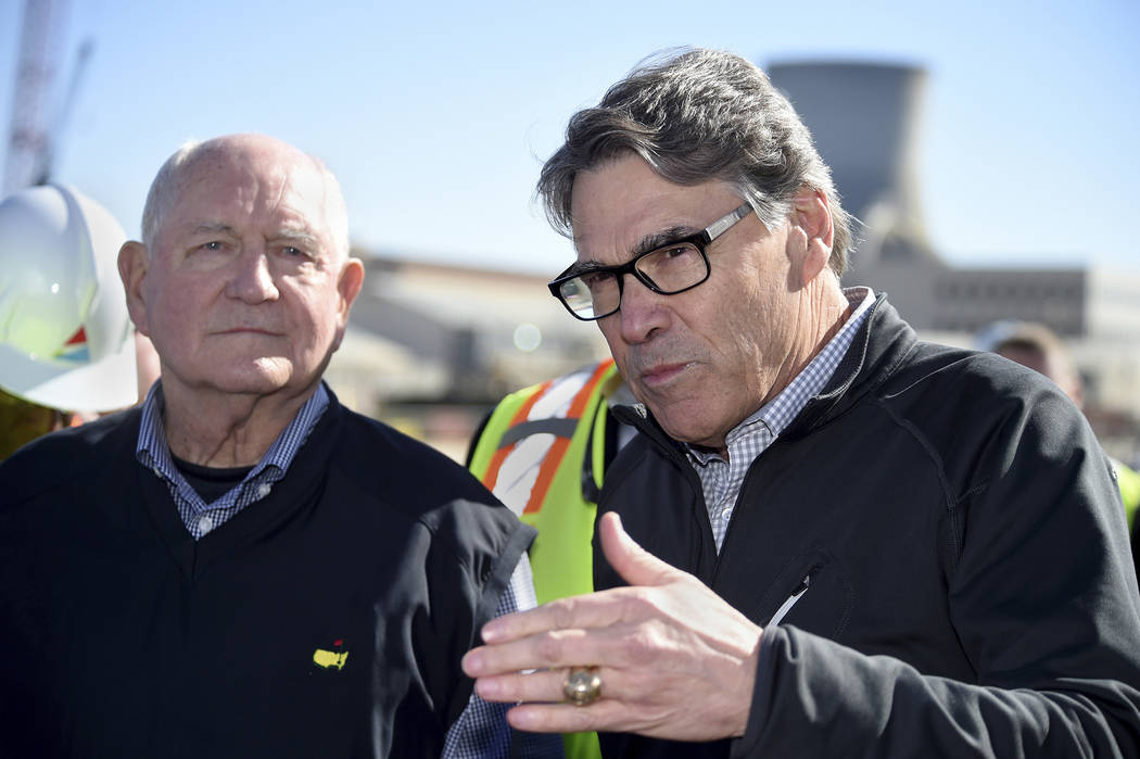 U.S. Secretary of Energy Rick Perry, right, and U.S. Secretary of Agriculture Sonny Perdue answer reporters questions at the Plant Vogtle nuclear energy facility in Waynesboro, Ga., Friday, March ...