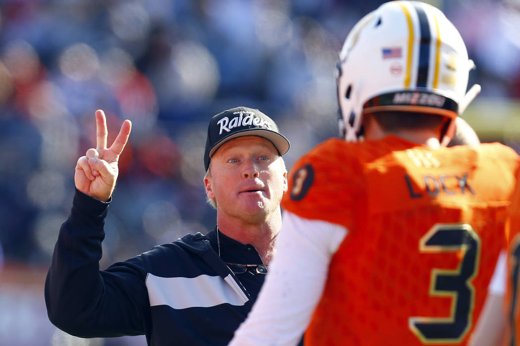 North head coach Jon Gruden, of the Oakland Raiders, talks with North quarterback Drew Lock, of Missouri, during the first half of the Senior Bowl college football game, Saturday, Jan. 26, 2019, i ...