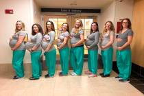=In this March 23, 2019 photo, eight labor and delivery nurses at Maine Medical Center hold up cards with their due dates in Portland, Maine. Nine nurses at the Portland hospital’s labor and del ...