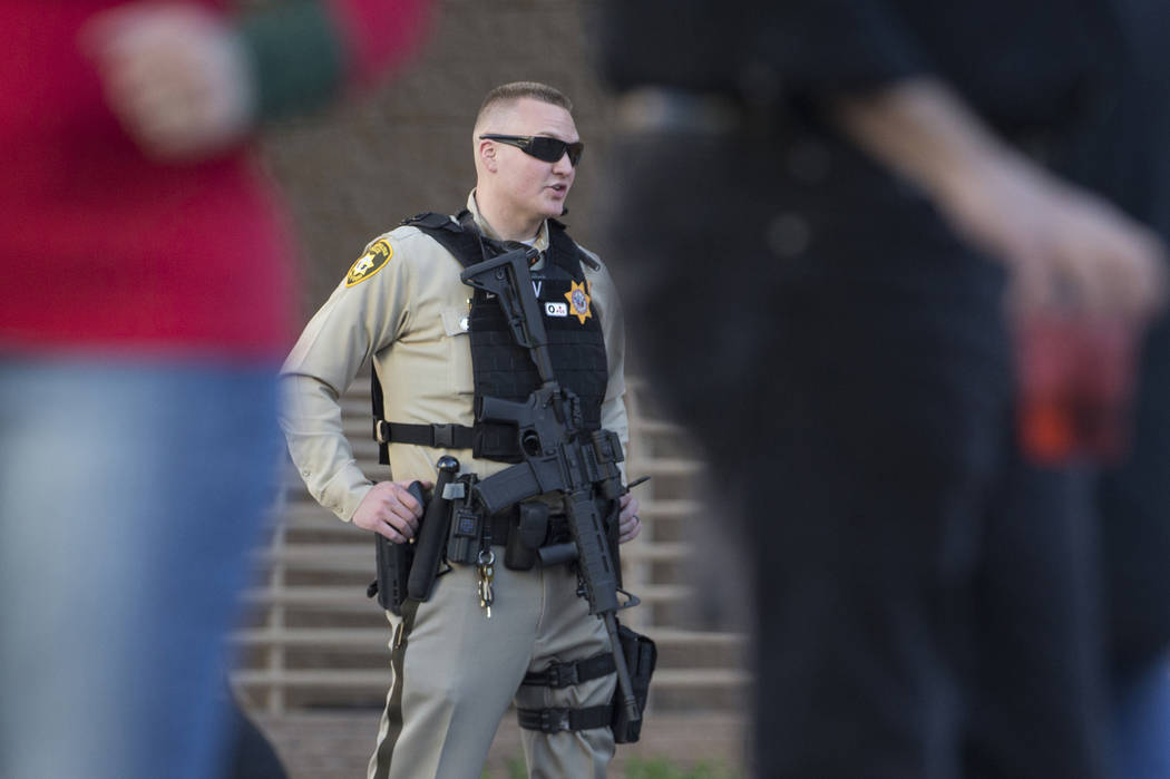 Metro officer Dallin Van Buskirk, armed with an AR-15 semi-automatic rifle with a scope, patrol ...