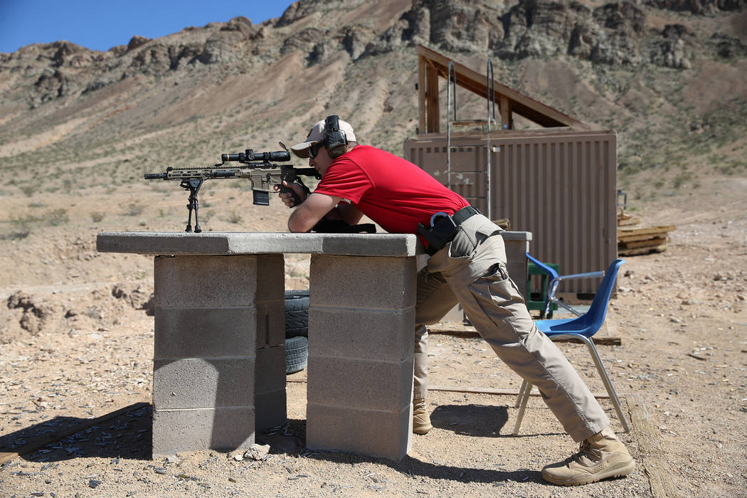 Las Vegas police Sgt. Shawn Romprey shoots his semi-automatic rifle at the Metropolitan Police ...