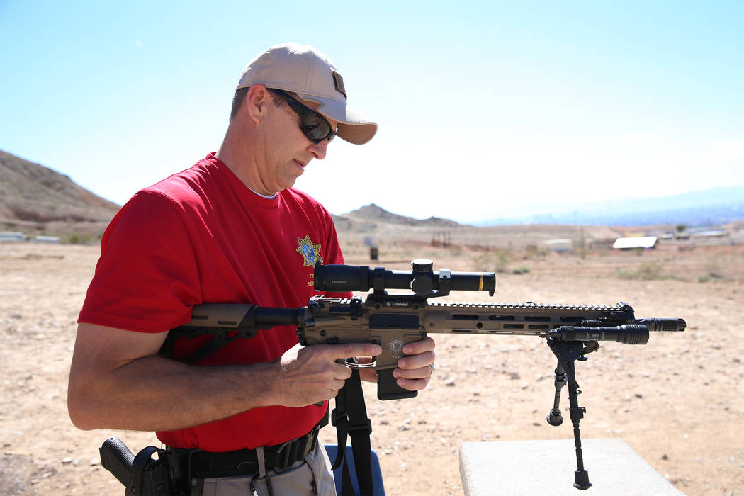 Las Vegas police Sgt. Shawn Romprey prepares to shoot his semi-automatic rifle at the Metropoli ...